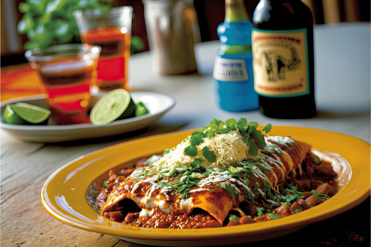 Plate of Enchiladas smothered in sauce and garnished with cilantro with limes in the background