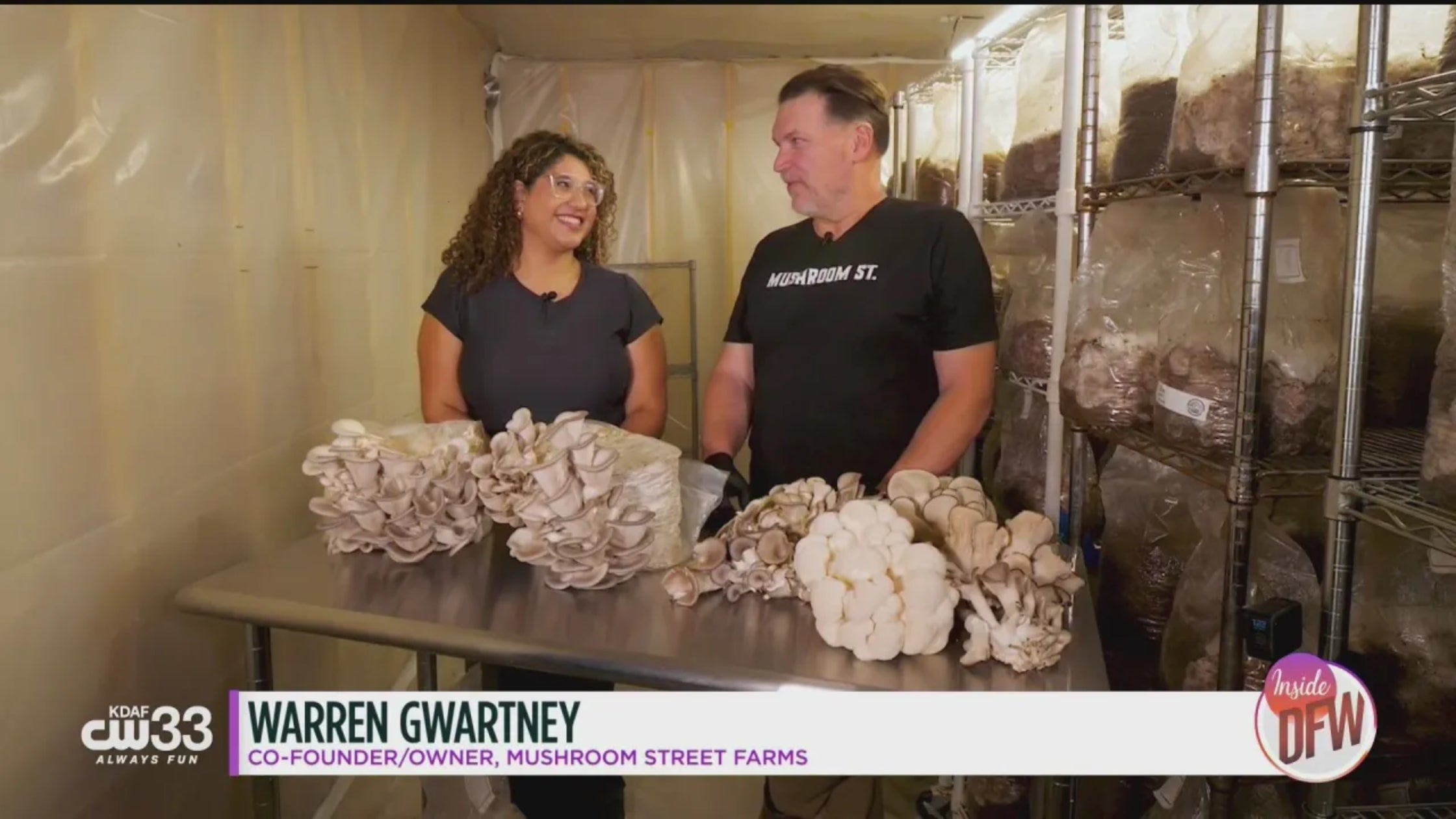 Warren Gwatney, co-founder of Mushroom Street Farms, holding oyster mushrooms during a CW33 television interview