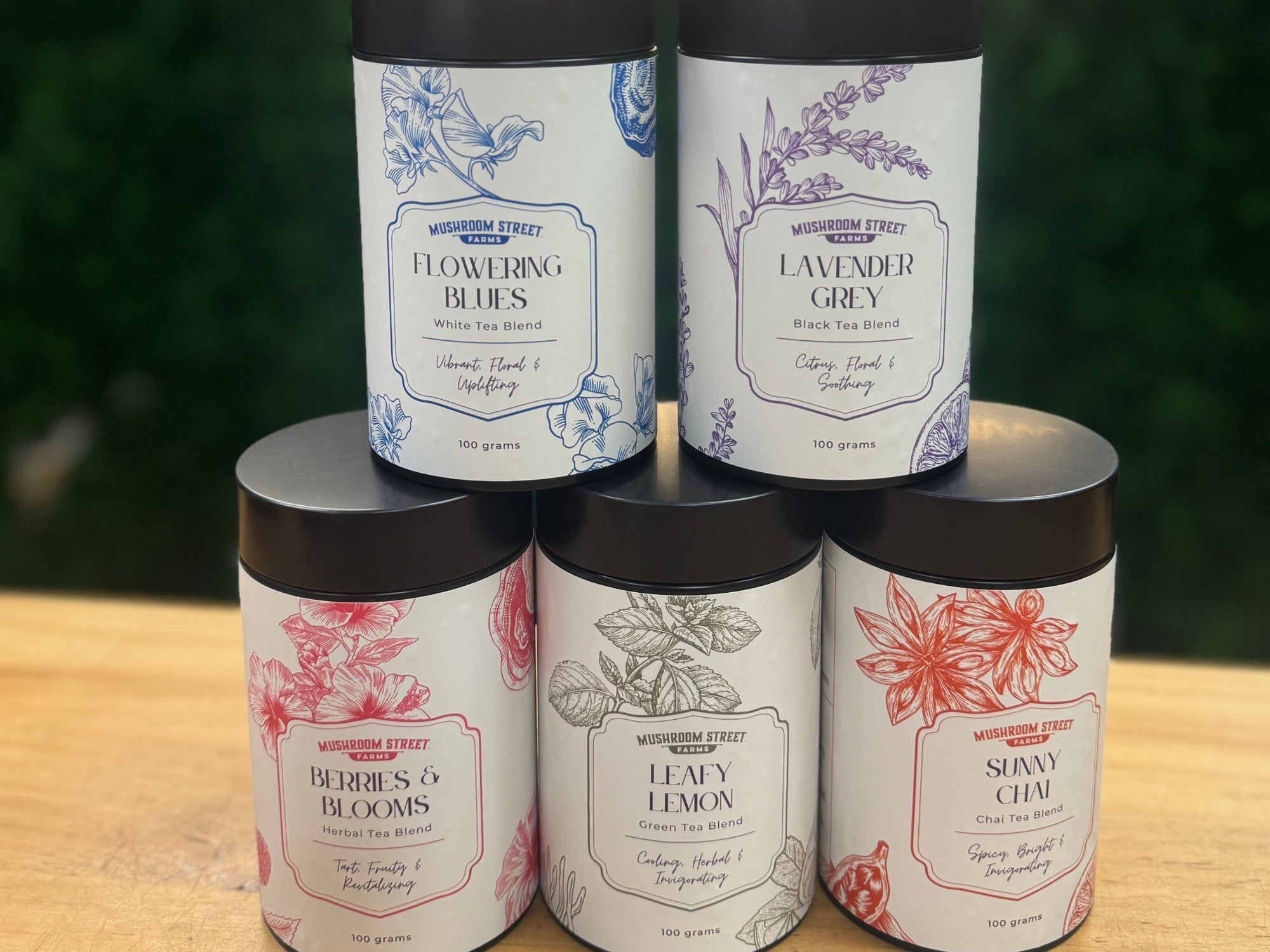 Five Mushroom Street Farms herbal tea tins arranged together